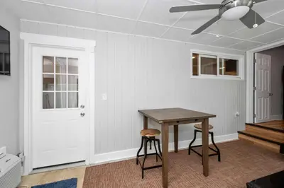 a dining room with a table and two stools at Hunley Haven Retreat in Cincinnati