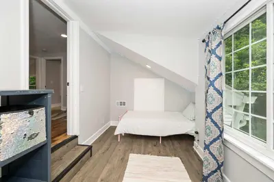 a room with a white bed and a window at Hunley Haven Retreat in Cincinnati