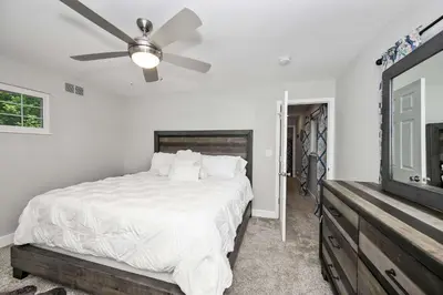 a bedroom with a bed and a ceiling fan at Hunley Haven Retreat in Cincinnati