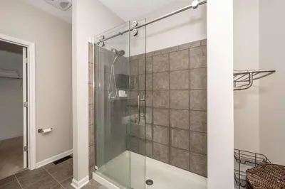 a shower with a glass door in a bathroom at Urban Escape in Cincinnati
