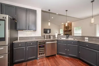 a kitchen with black cabinets and a sink at Urban Escape in Cincinnati