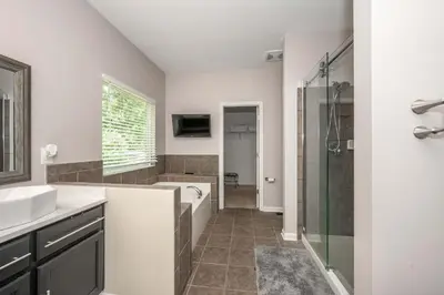 a bathroom with a tub and a sink and a shower at Urban Escape in Cincinnati