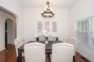 a dining room with a table with chairs and a chandelier at Urban Escape in Cincinnati