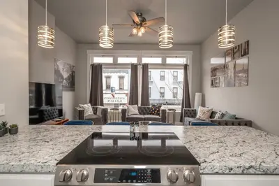 a kitchen with a stove and a living room at Heart of Madison 2 in Covington
