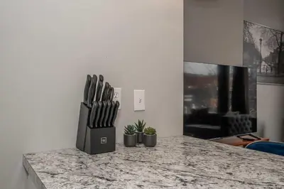 a kitchen counter with a knife block on it at Heart of Madison 2 in Covington