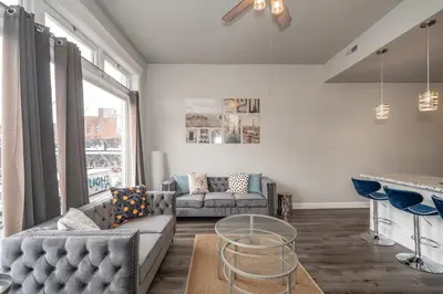 a living room with a couch and a table at Heart of Madison 2 in Covington