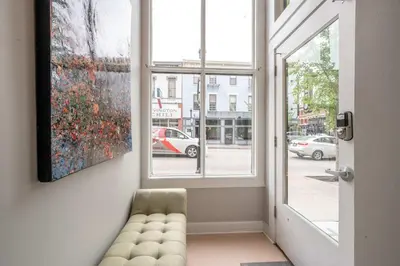 a room with a window with a couch and a painting at Heart of Madison 2 in Covington