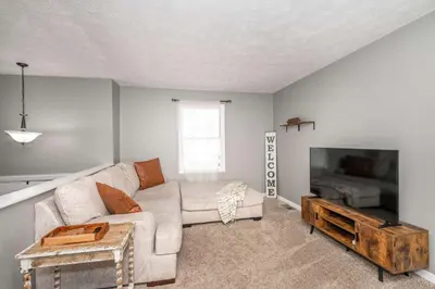 a living room with a couch and a flat screen tv at Cozy Home Away From Home in Florence