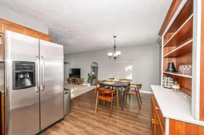 a kitchen with a table and a stainless steel refrigerator at Cozy Home Away From Home in Florence