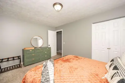 a bedroom with a bed with a mirror and a dresser at Cozy Home Away From Home in Florence