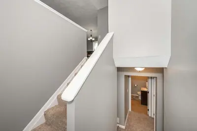 a staircase in a house with white walls at Cozy Home Away From Home in Florence