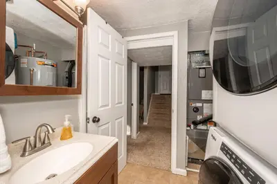 a bathroom with a sink and a washing machine at Cozy Home Away From Home in Florence