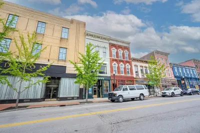 a city street with cars parked in front of buildings at The Heart of Madison 3 in Covington