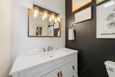a bathroom with a white sink and a mirror at The Luxe Pearl Residences 870-5 in Columbus