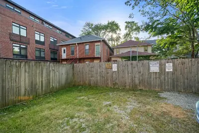 a wooden fence in front of a brick building at North Pearl Residences 874 in Columbus