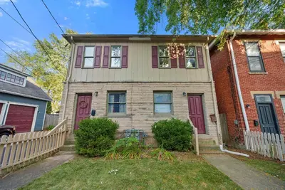 a house with red doors and a white fence at North Pearl Residences 874 in Columbus