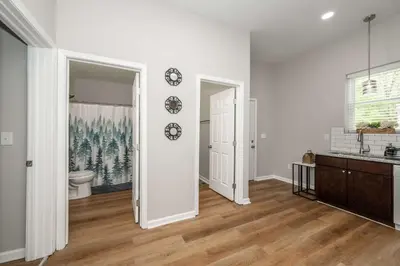 a white room with a toilet and a sink at Queen City Retreat 1 Cozy Home for 6 Near Attractions & Restaurants in Cincinnati