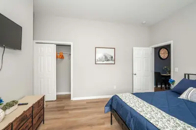 a bedroom with a bed and a tv in it at Queen City Retreat 1 Cozy Home for 6 Near Attractions & Restaurants in Cincinnati