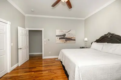 a bedroom with a bed and a ceiling fan at The Bishops Manor Stay for 10 in West Chester