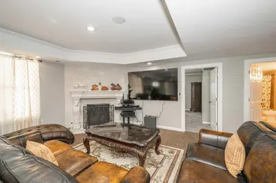 a living room with leather furniture and a fireplace at The Bishops Manor Stay for 10 in West Chester