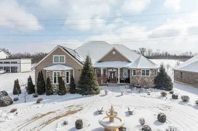 a house in the snow with a fountain at The Bishops Manor Stay for 10 in West Chester