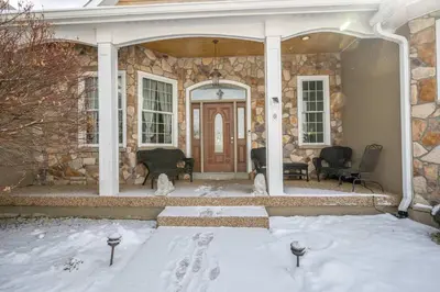 a stone house with snow on the ground at The Bishops Manor Stay for 10 in West Chester