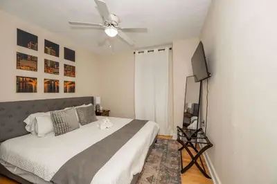 a bedroom with a bed and a ceiling fan at La Dolce Vita Retreat w Hot Tub in Columbus