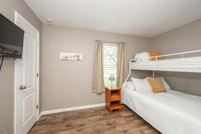 a bedroom with two bunk beds and a window at Main Street Cottage For 6 in Monroe