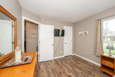 a living room with a desk and a door at Main Street Cottage For 6 in Monroe
