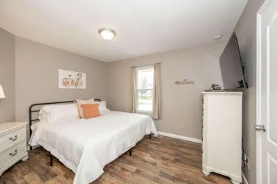 a bedroom with a bed and a window at Main Street Cottage For 6 in Monroe