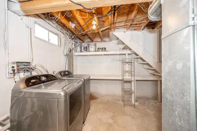 a kitchen with a sink and a staircase in a room at Main Street Cottage For 6 in Monroe