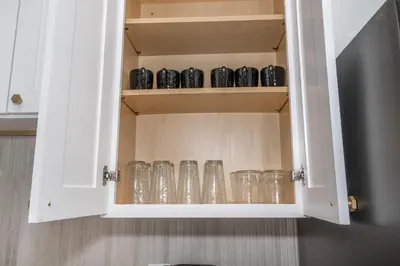 a cupboard filled with glasses and mugs at Covington Charm 202 in Covington