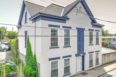 a white and blue house with a blue door at Covington Charm 202 in Covington