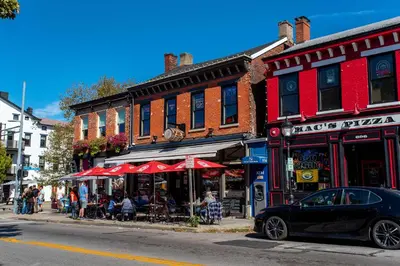 a black car parked in front of a restaurant on a street at Covington Charm 202 in Covington