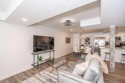 a living room with a couch and a kitchen at Covington Charm 101 in Covington