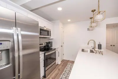 a kitchen with a stainless steel refrigerator and a sink at Covington Charm 101 in Covington