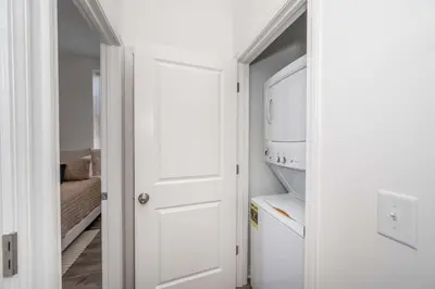 a kitchen with a white door and a refrigerator at Covington Charm 201 in Covington