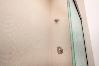 a shower with a glass door with a shower curtain at Covington Charm 201 in Covington