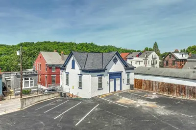 an empty parking lot with a white house at Covington Charm 201 in Covington