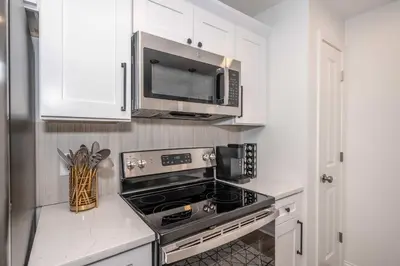 a kitchen with a stove and a microwave at New Listing - Covington Charm Suites in Covington