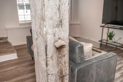 a wooden pole in a living room with a couch at New Listing - Covington Charm Suites in Covington