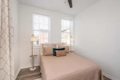 a bedroom with a bed and two windows at New Listing - Covington Charm Suites in Covington