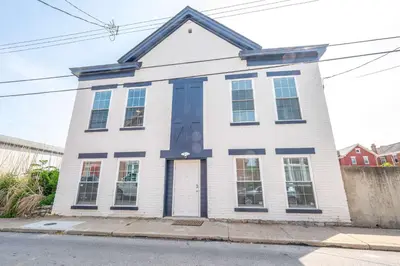 a white house with blue trim on a street at New Listing - Covington Charm Suites in Covington