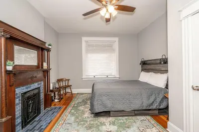a bedroom with a bed and a fireplace at Suites on Main 1 in Covington