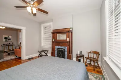 a bedroom with a bed and a fireplace at Suites on Main 1 in Covington