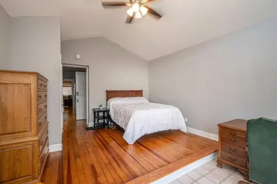 a bedroom with a bed and a ceiling fan at Suites on Main 1 in Covington