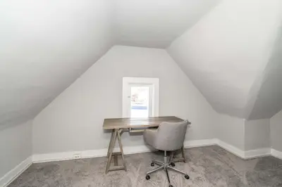a desk and a chair in a attic at Suites on Main 3 in Covington