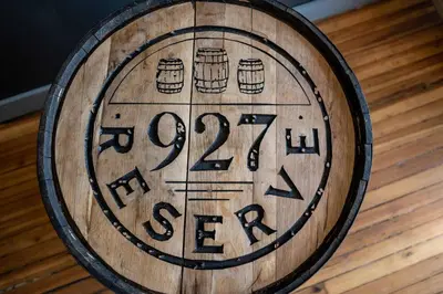 a wooden barrel with abeer sign on a wooden floor at New Monmouth Loft 1 - City Chic 1 BDR in Newport