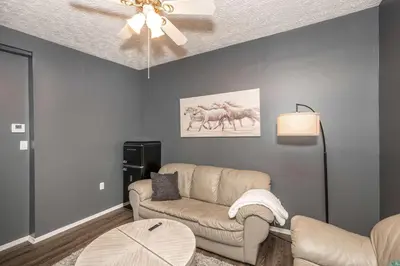 a living room with a couch and a ceiling fan at Monmouth Loft 4 - Walk to Shops in Newport