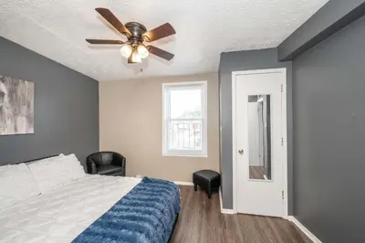 a bedroom with a bed and a ceiling fan at Monmouth Loft 4 - Walk to Shops in Newport